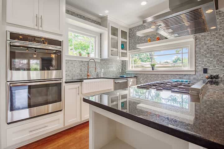 An image of a modern kitchen with sleek appliances, featuring a gas stove, refrigerator, and built-in microwave in Lucas